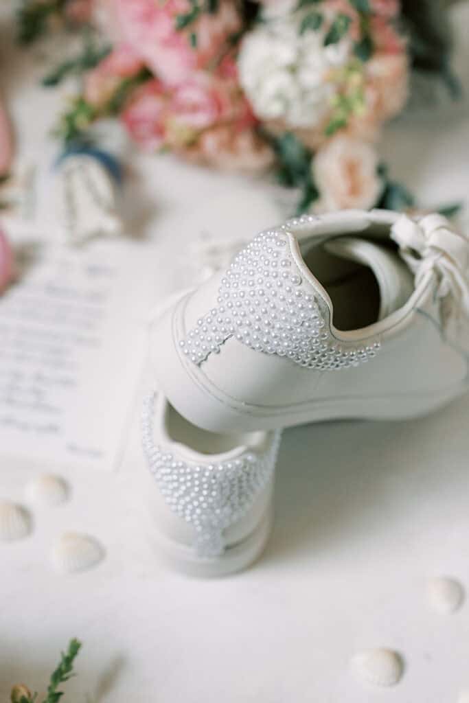 Pearl-embellished white bridal sneakers with pink and blush wedding bouquet, Rehoboth Beach Delaware wedding details