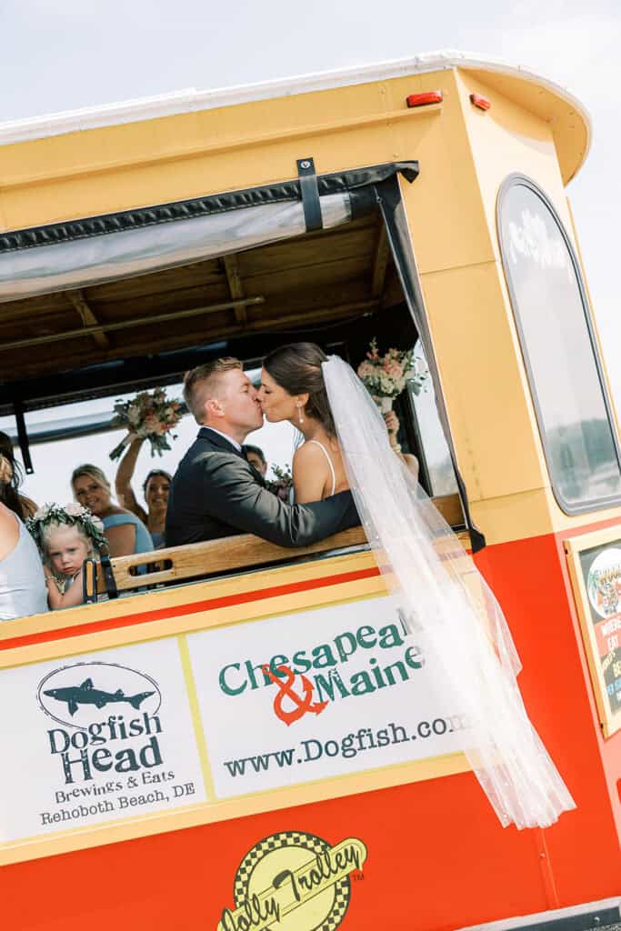 Bride and groom kissing on the Jolly Trolley after beach wedding ceremony at Rehoboth Beach Delaware, Samantha Jay Photo