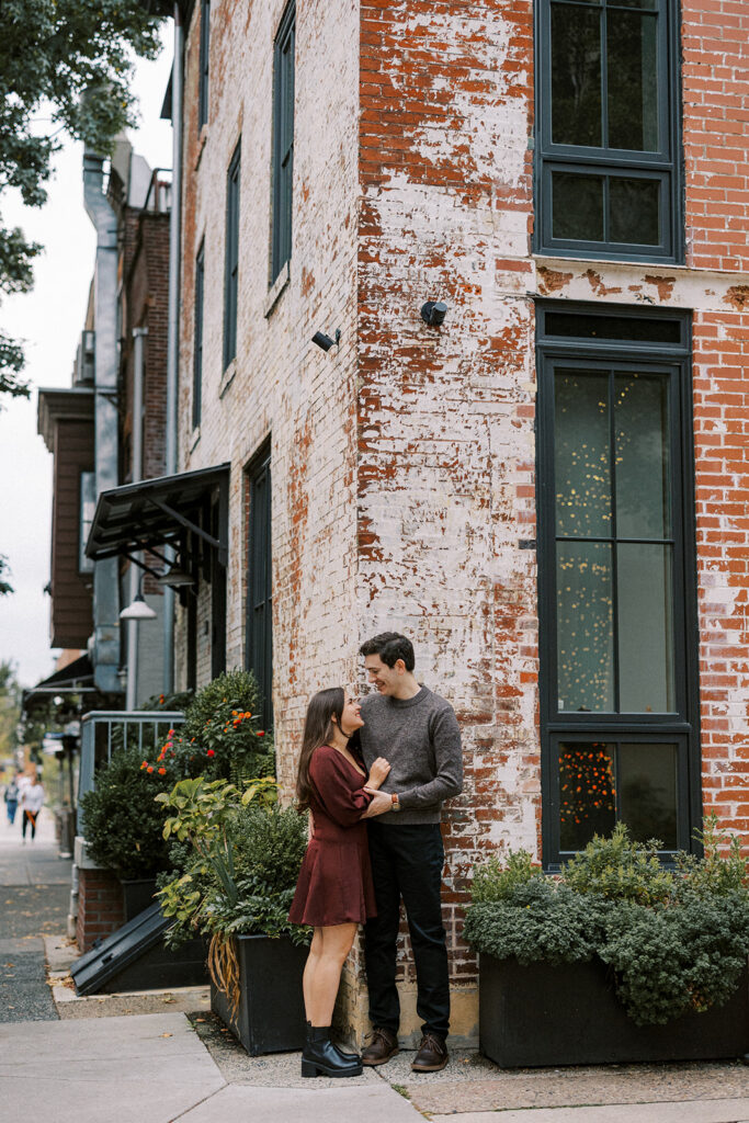 Amy and Chas pause by a white washed brick home in the residential backstreets near Rittenhouse Square