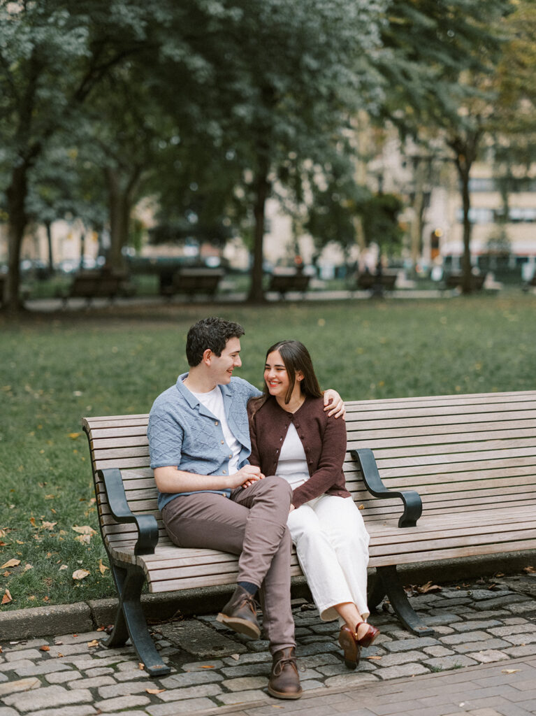 Amy and Chas sharing a quiet moment on a park bench at Rittenhouse Square
